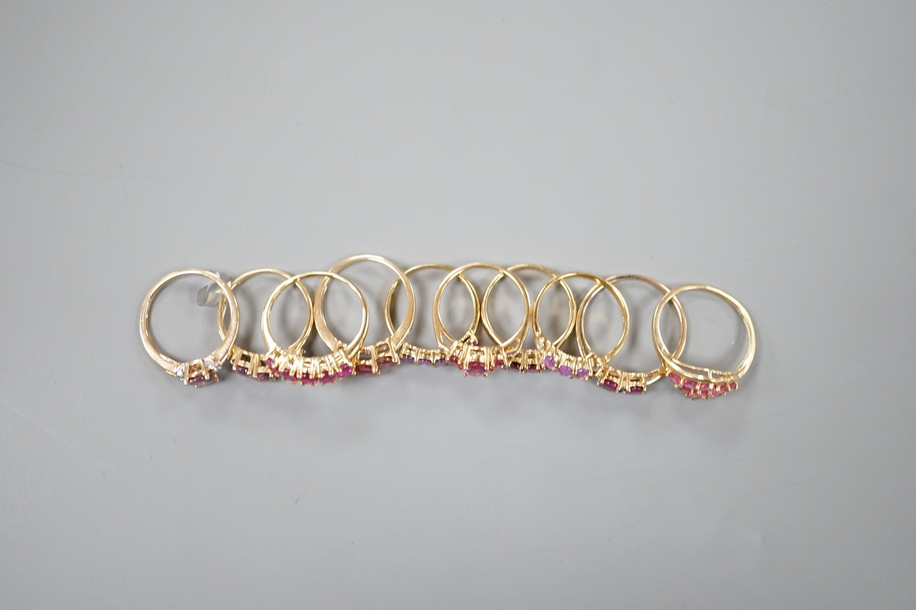 Ten assorted modern 9ct and gem set dress rings including rubellite, gross weight 18.8 grams.